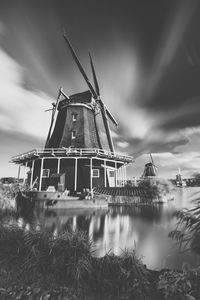 Traditional windmill against cloudy sky