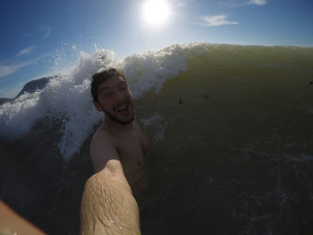 Portrait of smiling young man in sea