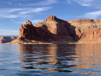 Scenic view of rock formation in sea against sky