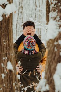 Couple standing in forest during winter