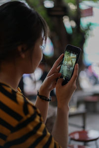 Close-up of woman using mobile phone