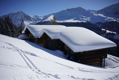 Scenic view of snow covered mountains against sky