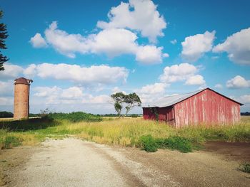 Built structure on field against cloudy sky