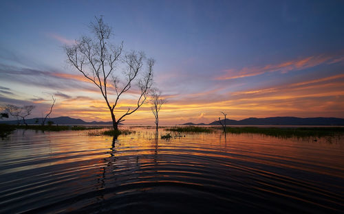 Scenic view of lake against sky during sunset