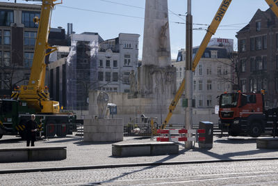 Vehicles on road against buildings in city