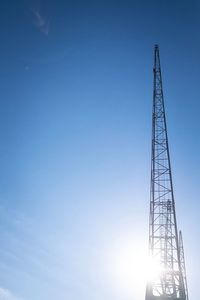 Low angle view of crane against clear blue sky