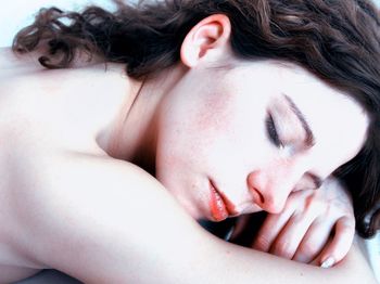 Close-up of shirtless woman sleeping