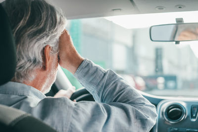 Senior man driving car