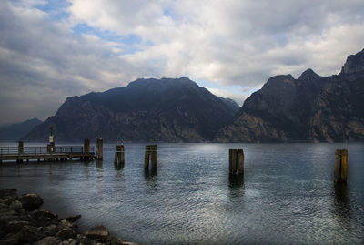 Scenic view of sea and mountains against sky