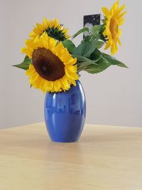 Close-up of yellow flower pot on table