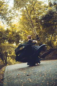 Woman dancing in dress in forest