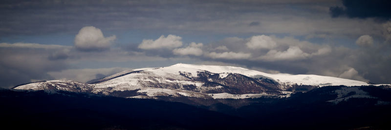 Scenic view of snowcapped mountains against sky