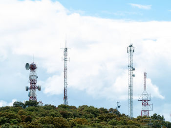 Low angle view of communications tower against sky