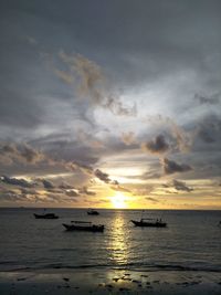 Scenic view of sea against dramatic sky during sunset