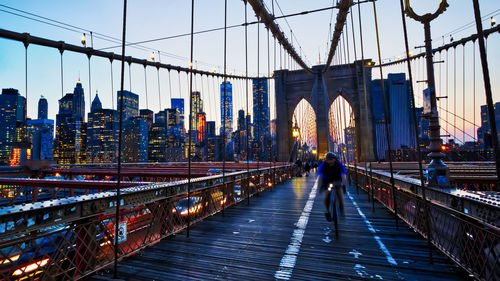 People walking on footbridge in city