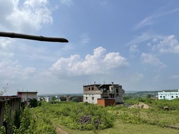 Houses on field against sky
