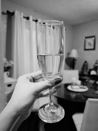 Close-up of hand holding drink on table