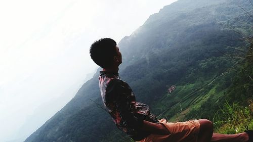 Rear view of man looking at mountains