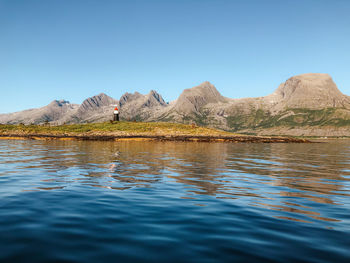 Scenic view of lake against clear blue sky