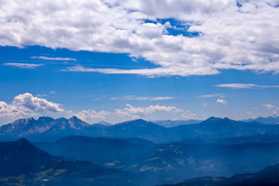 Scenic view of mountains against blue sky