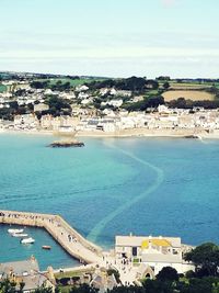 High angle view of buildings by sea against sky