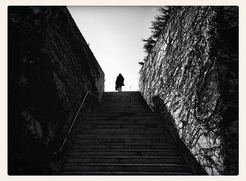 Low angle view of people walking on steps