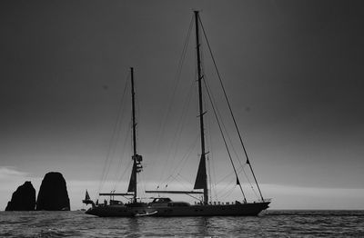 Silhouette of sailboat sailing on sea