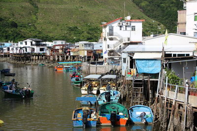 High angle view of boats moored at harbor by buildings