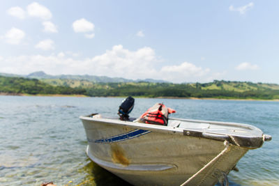 Boat moored on sea against sky