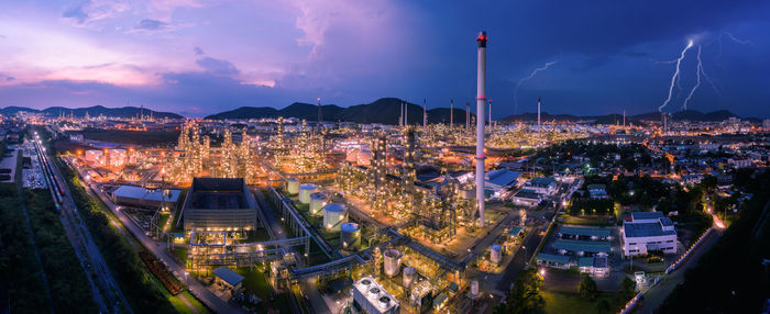 Twilight cityscape panorama oil and gas refinery industry factory zone and storage tank 