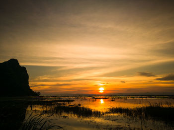 Scenic view of lake against romantic sky at sunset