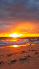 Scenic view of sea against romantic sky at sunset