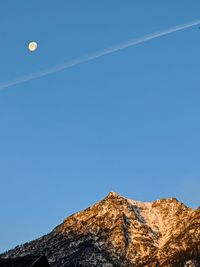 Low angle view of rock formation against clear blue sky