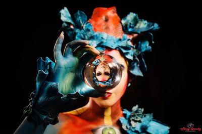 Close-up portrait of woman statue against black background