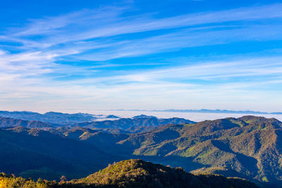 Scenic view of mountains against blue sky