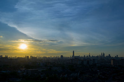 Cityscape against sky during sunset