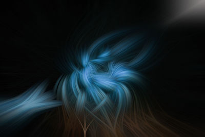 Abstract image of illuminated light painting against black background