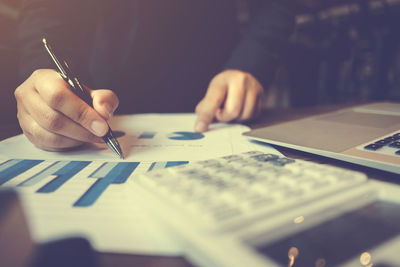 Close-up of man working in pen