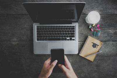 Directly above view of person using laptop on table