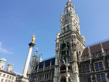 Low angle view of statue against blue sky