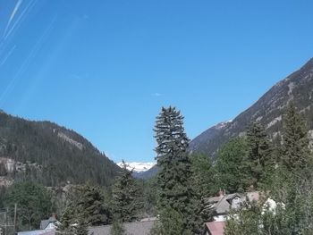 Scenic view of mountains against clear blue sky