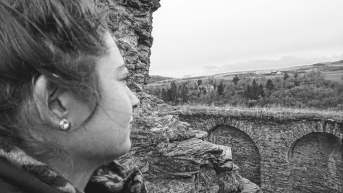 Close-up of person on field against sky