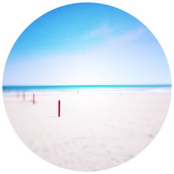 Close-up of beach against clear blue sky