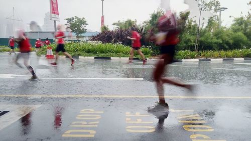 Woman standing by tree