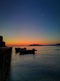 Scenic view of sea against clear sky during sunset