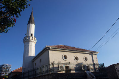 Low angle view of building against clear blue sky