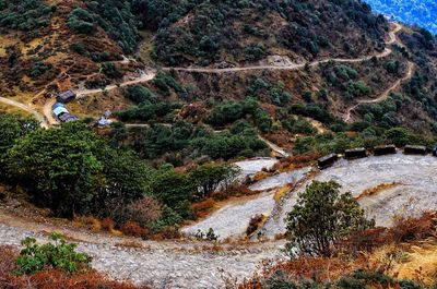 Scenic view of river by mountains against sky