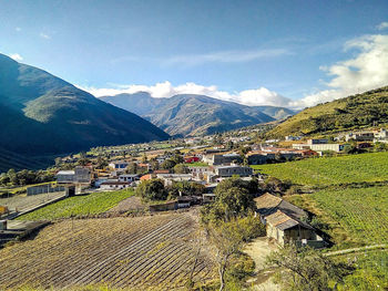 High angle view of houses by mountains against sky