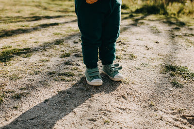 Low section of man walking on dirt