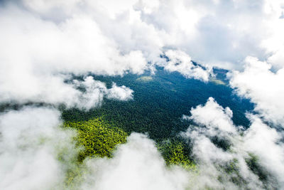 Aerial view of clouds over green landscape